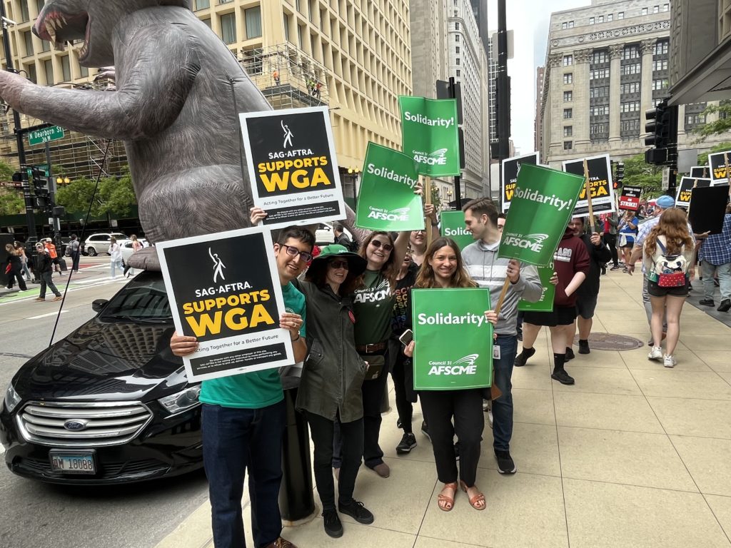 Local 1215 members picket in support of the Writers' Guild of America strike.