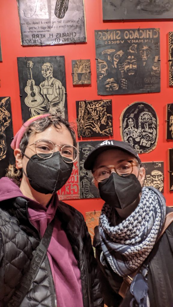 Photo of two Local 1215 members standing in front of a wall at the Carlos Cortéz exhibit at the National Mexican Museum of Art.