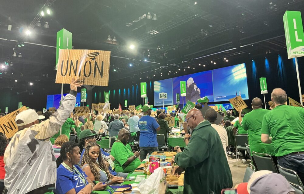 AFSCME members on the convention floor paint signs.